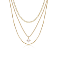 A layered gold necklace set featuring three distinct chain styles: a delicate cable chain, a Figaro link chain, and a tennis chain with a small clear gemstone pendant, displayed on a clean white background.