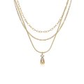 A gold layered necklace featuring three distinct chain styles (snake chain, figaro chain, and cable chain) with a teardrop-shaped pendant set with clear gemstones, shown on a plain white background.