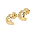 A pair of gold-colored textured curved hoop earrings with a croissant-inspired silhouette.