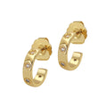 Gold hoop earrings with embedded diamonds on a white background