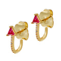 A pair of gold-colored hoop earrings with red stone accents and gold accents on the hoops.
