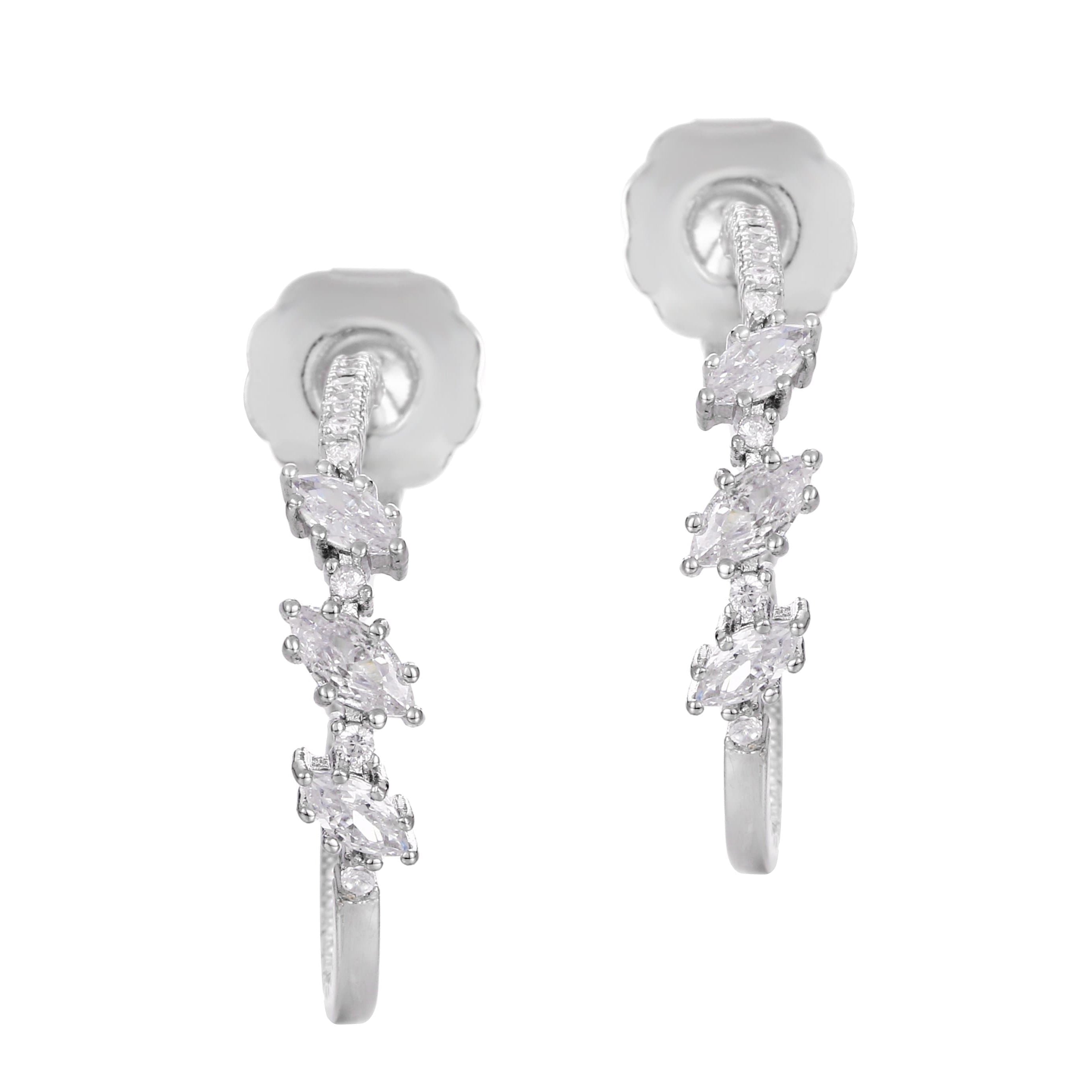 A pair of white gold earrings with intricate designs and drop features, showcasing multiple gemstones.